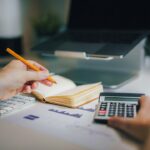 Financial planning desk with calculator and cash-flow analysis representing the working capital required as Sellvia order volume grows